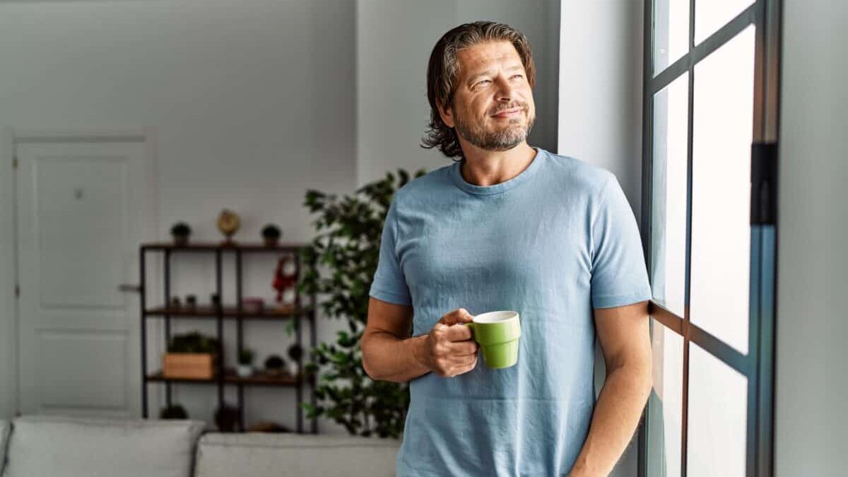 Middle aged man drinks coffee