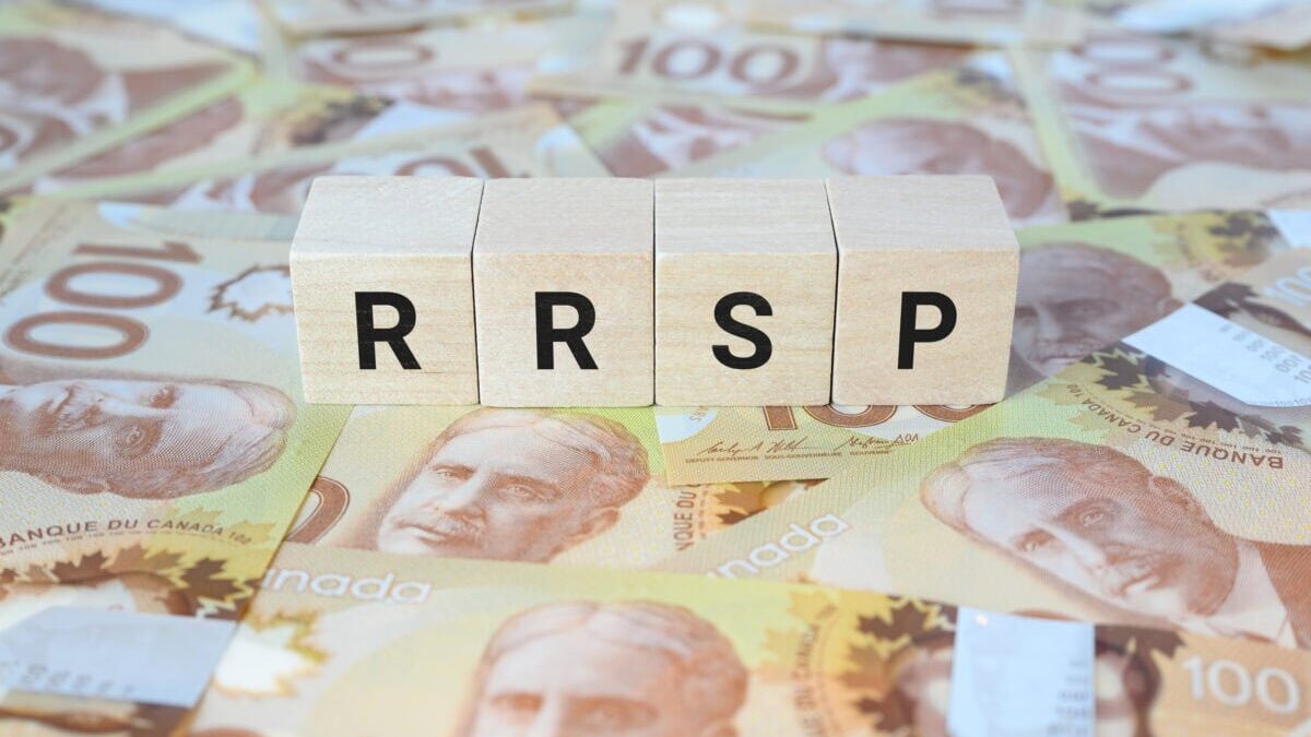 RRSP (Registered Retirement Savings Plan) on wooden blocks and Canadian one hundred dollar bills.